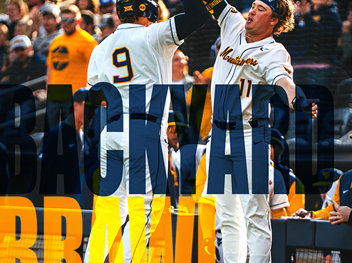 two wvu baseball players jumping together in the air