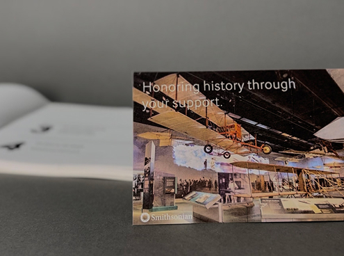 photo of smithsonia donors card with book oopened behind